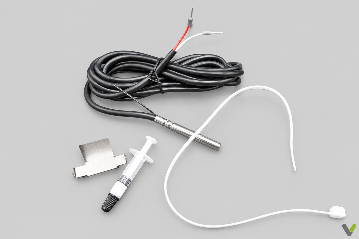 TAF PT metal temperature probe with black cable and pictured fitting items on flat light grey background with corner V